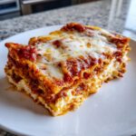 A thick, layered slice of Lasagna with Cottage Cheese topped with melted mozzarella and rich tomato sauce.