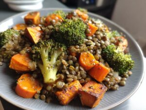 Close-up of a vibrant veggie lentil salad featuring green lentils, roasted sweet potato chunks, and bright green broccoli florets.