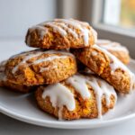 A stack of freshly baked persimmon cookies drizzled generously with white vanilla glaze.