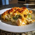 A close-up serving of creamy Chicken Divan with broccoli florets and a crispy, golden breadcrumb topping.