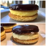 Two delicious boston cream pie cookies showing a vanilla cream filling between two shortbread-like layers topped with chocolate ganache.