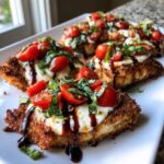 Close-up of crispy caprese chicken cutlets topped with melted mozzarella, cherry tomatoes, basil, and balsamic glaze.