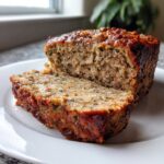 A close-up of a sliced stove top stuffing meatloaf showing the moist interior texture.