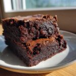 Close-up of a rich, fudgy slice of black bean brownies no sugar stacked on a small plate.